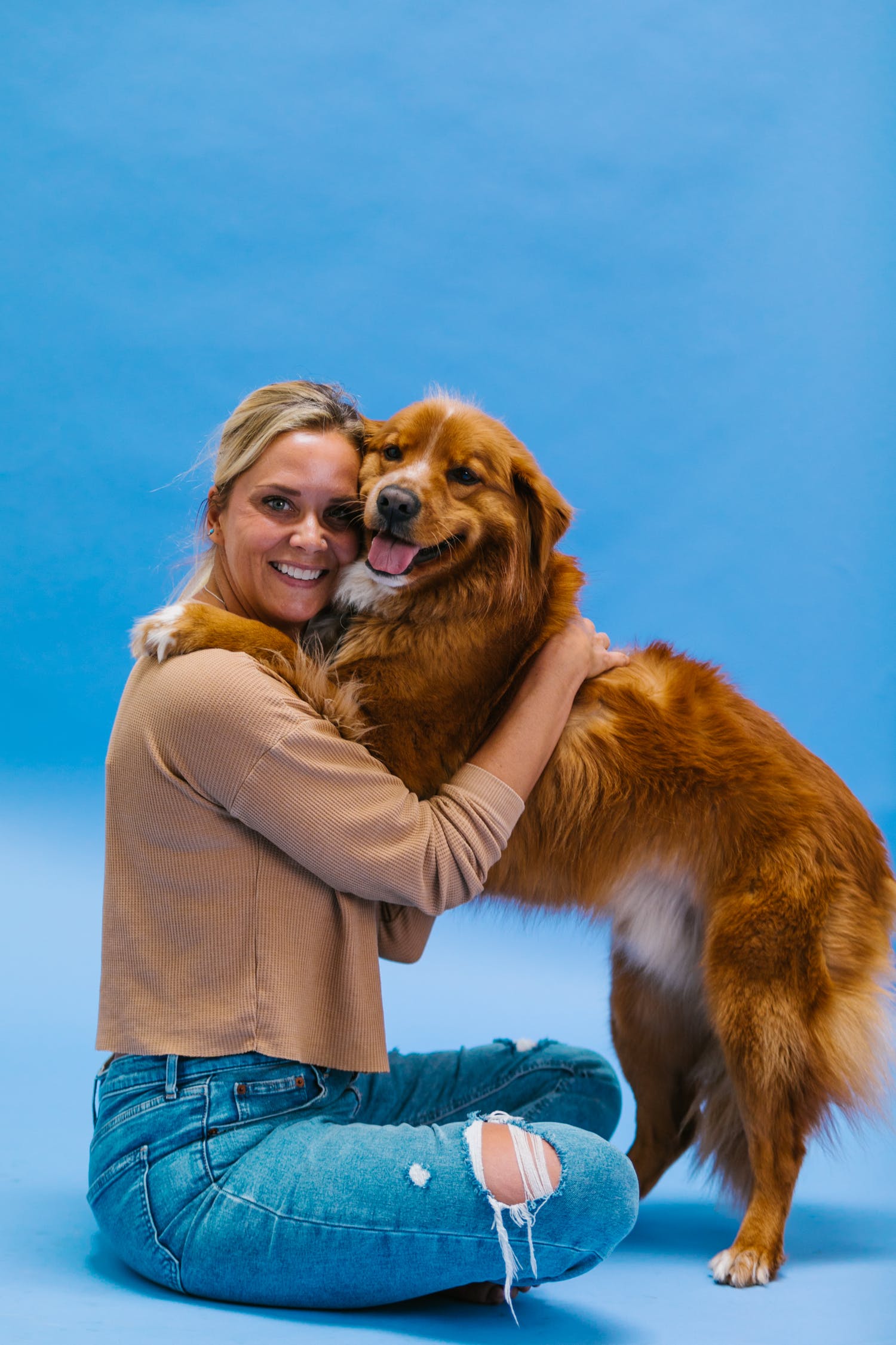 Woman hugging Golden Shepherd Mix