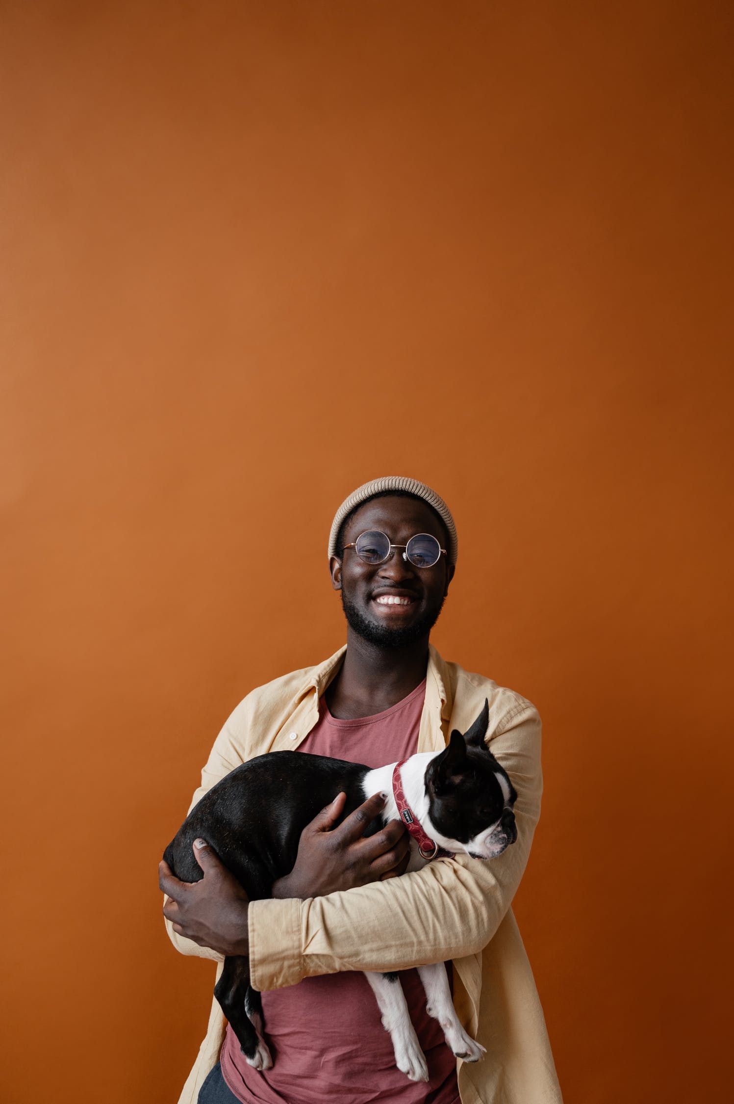 Man holding Boston Terrier