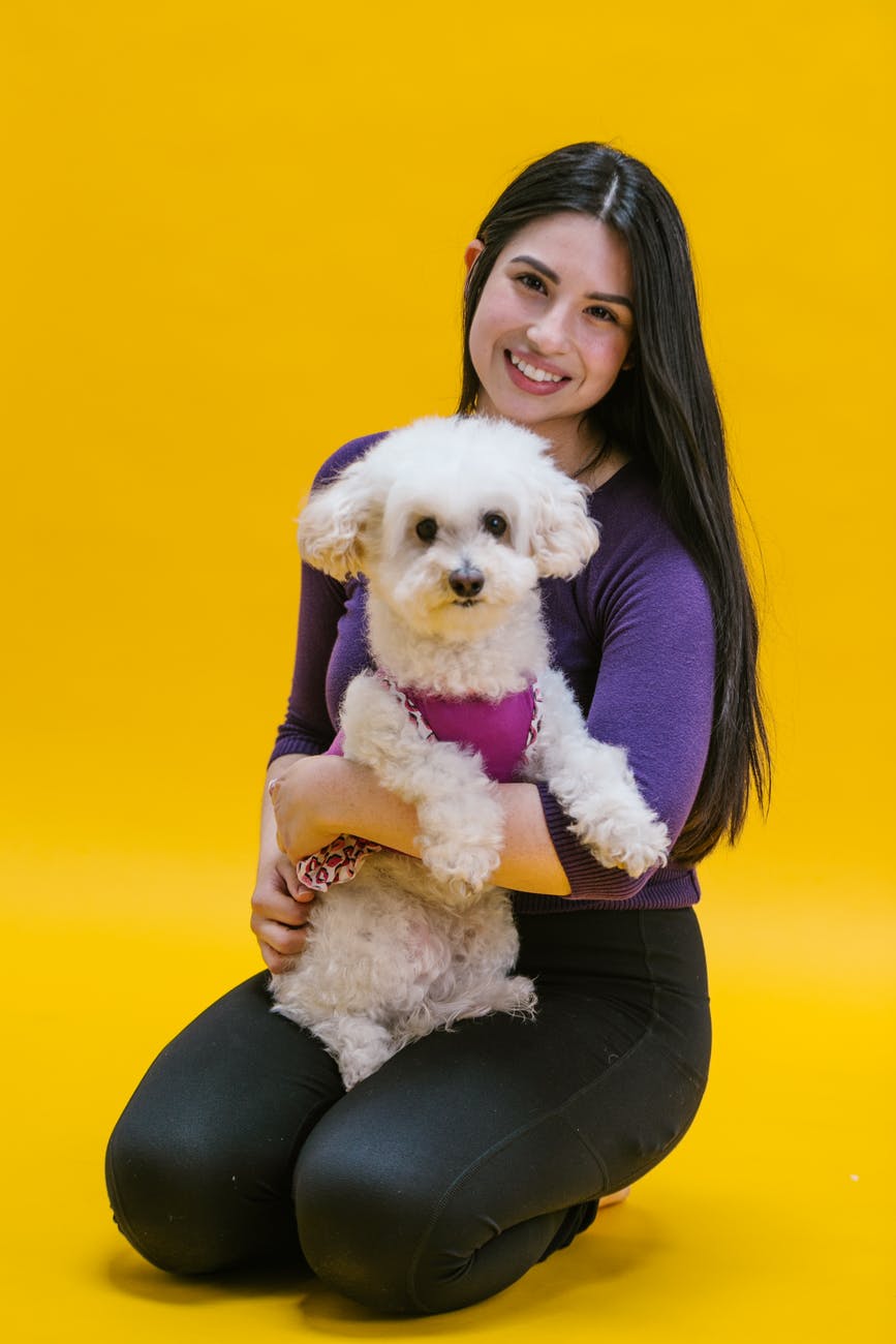 Woman sitting with white Poodle mix